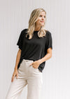 Model wearing a black short sleeve top with a slightly cropped fit and a bamboo viscose material.
