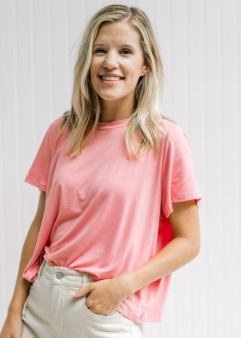 Model wearing a pink slightly cropped short sleeve top with a bamboo viscose material. 