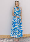 Model wearing heels and a cream and blue floral maxi with lace inset at bodice and tie waist.