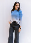 Model wearing jeans with a two toned blue sweater with long sleeves, nylon material and round neck. 