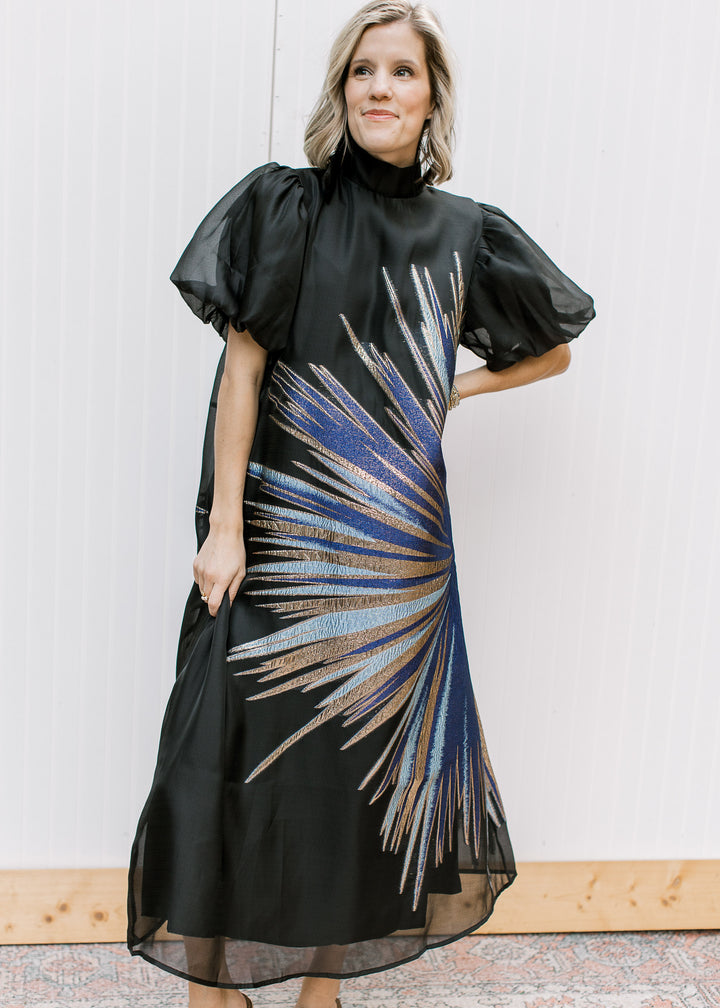 Front view of Blue Flame Dress with metallic blue and gold starburst, black sheer overlay and short bubble sleeves.