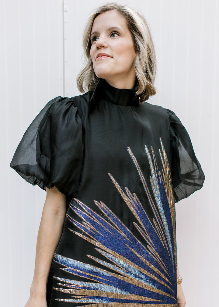 Front close-up of Blue Flame Dress showing black mock neckline, sheer bubble sleeves and metallic starburst detail.