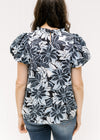 Back view of navy and white floral top with short puff sleeves and a keyhole closure. 