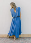 Back view of a blue set, top is a cropped balloon fit with keyhole with matching midi skirt.