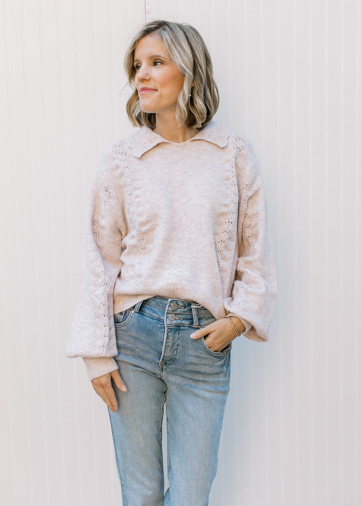 Model wearing jeans and a soft blush sweater with scalloped flap collar, long sleeves.