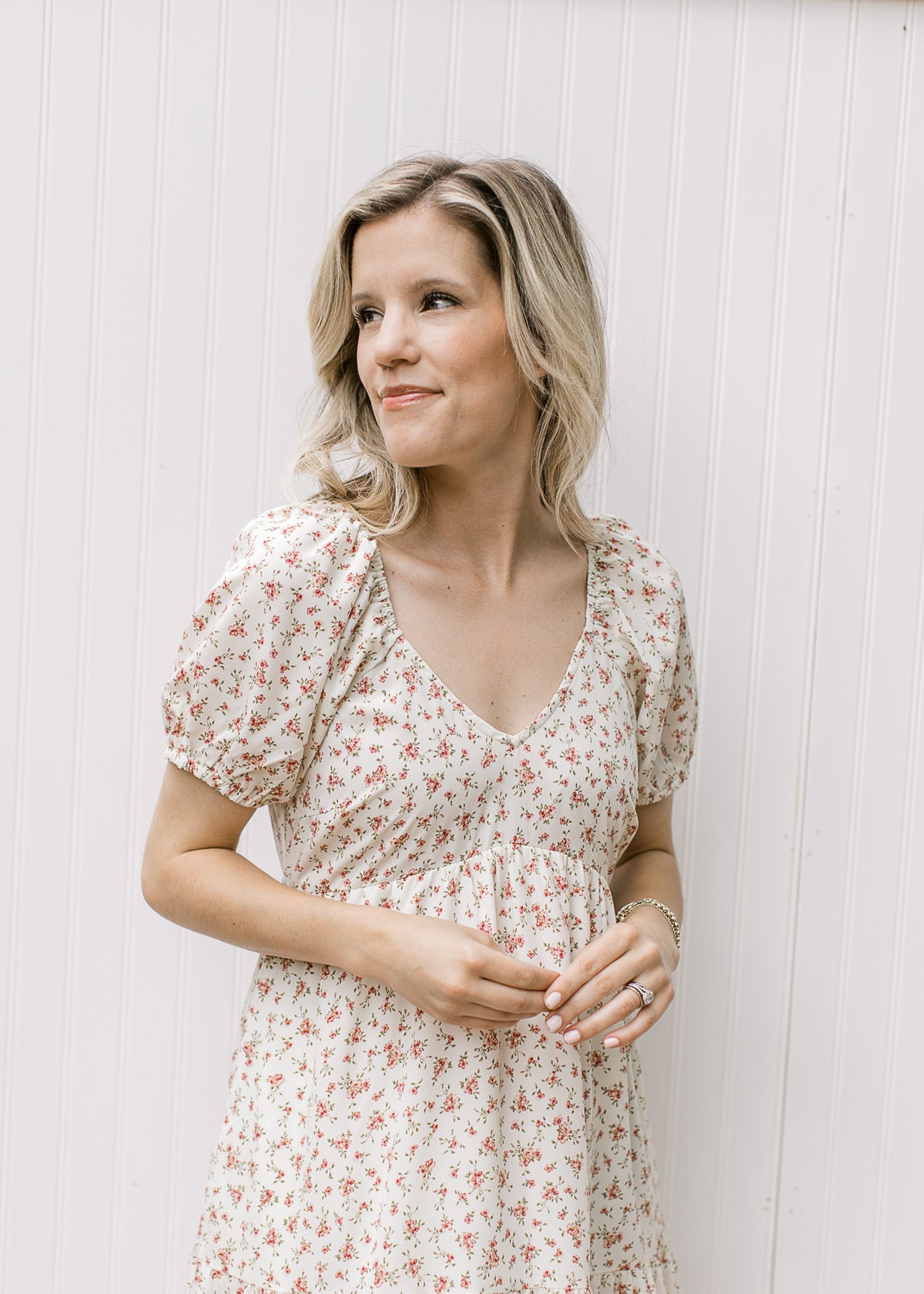 Close up of v-neck and bubble short sleeves on a cream maxi with pink ditsy floral pattern. 