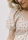 Close up of bubble short sleeve on a cream maxi with pink ditsy floral and a v-neck. 