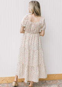 Back view of square neck and bubble short sleeves on a cream maxi with pink ditsy flowers. 