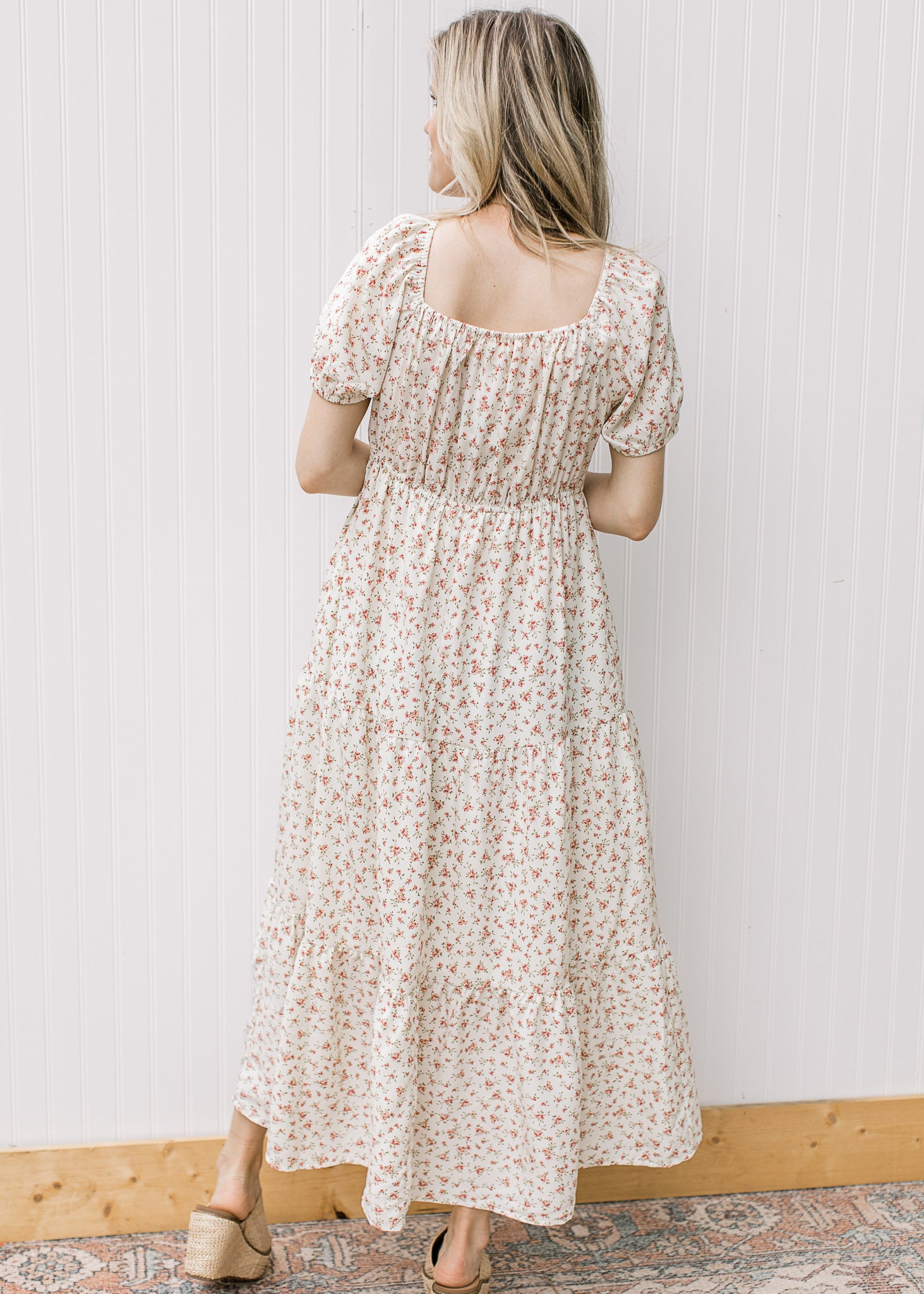 Back view of square neck and bubble short sleeves on a cream maxi with pink ditsy flowers. 