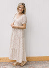 Model wearing wedges and a cream tiered maxi with pink microfloral, v-neck and bubble short sleeves.