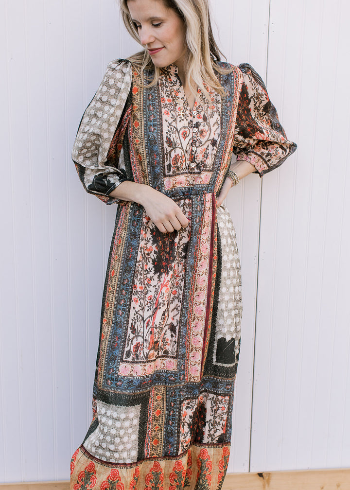 Model wearing a multicolored bohemian patterned midi with a v-neck, 3/4 sleeves and elastic waist.