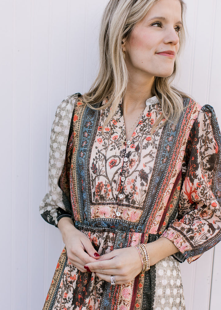 Close up of v-neck with buttons, elastic waist and bubble 3/4 sleeves on a bohemian midi. 