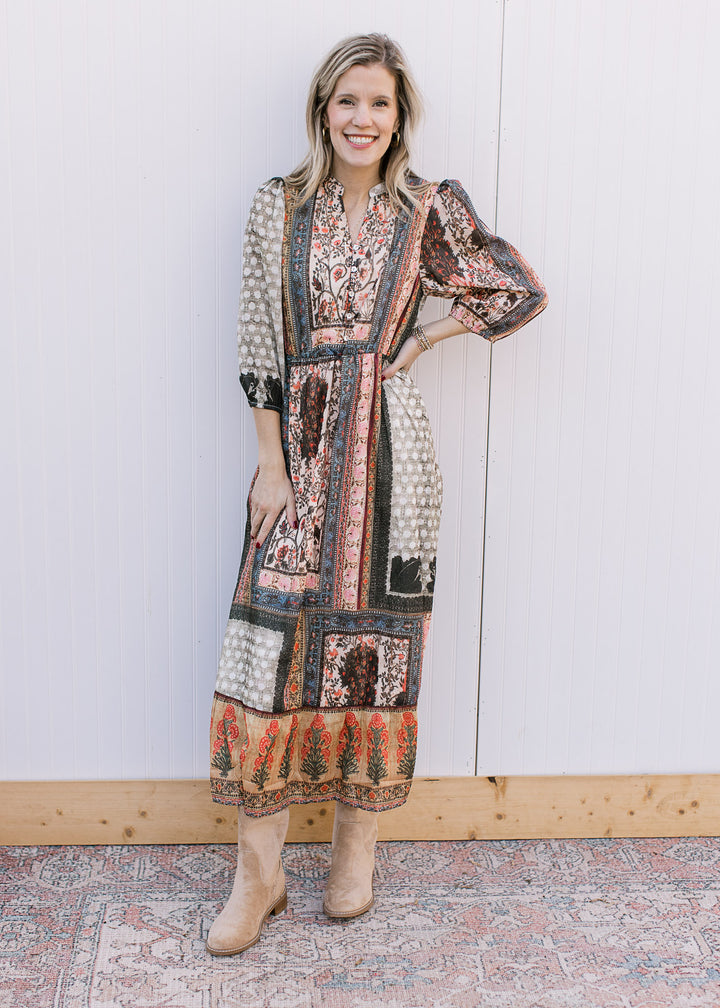 Model wearing boots and a bohemian patterned midi with a v-neck, 3/4 sleeves and elastic waist.