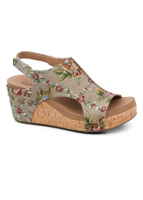 Outside view of taupe floral brocade fabric on a wedge open toe sandal with velcro straps. 