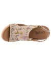 Top down view of taupe floral brocade fabric on a wedge open toe sandal with velcro straps. 