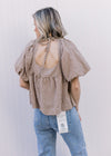 Back view of tie at neck on a brown and white checkered top with bubble short sleeves.