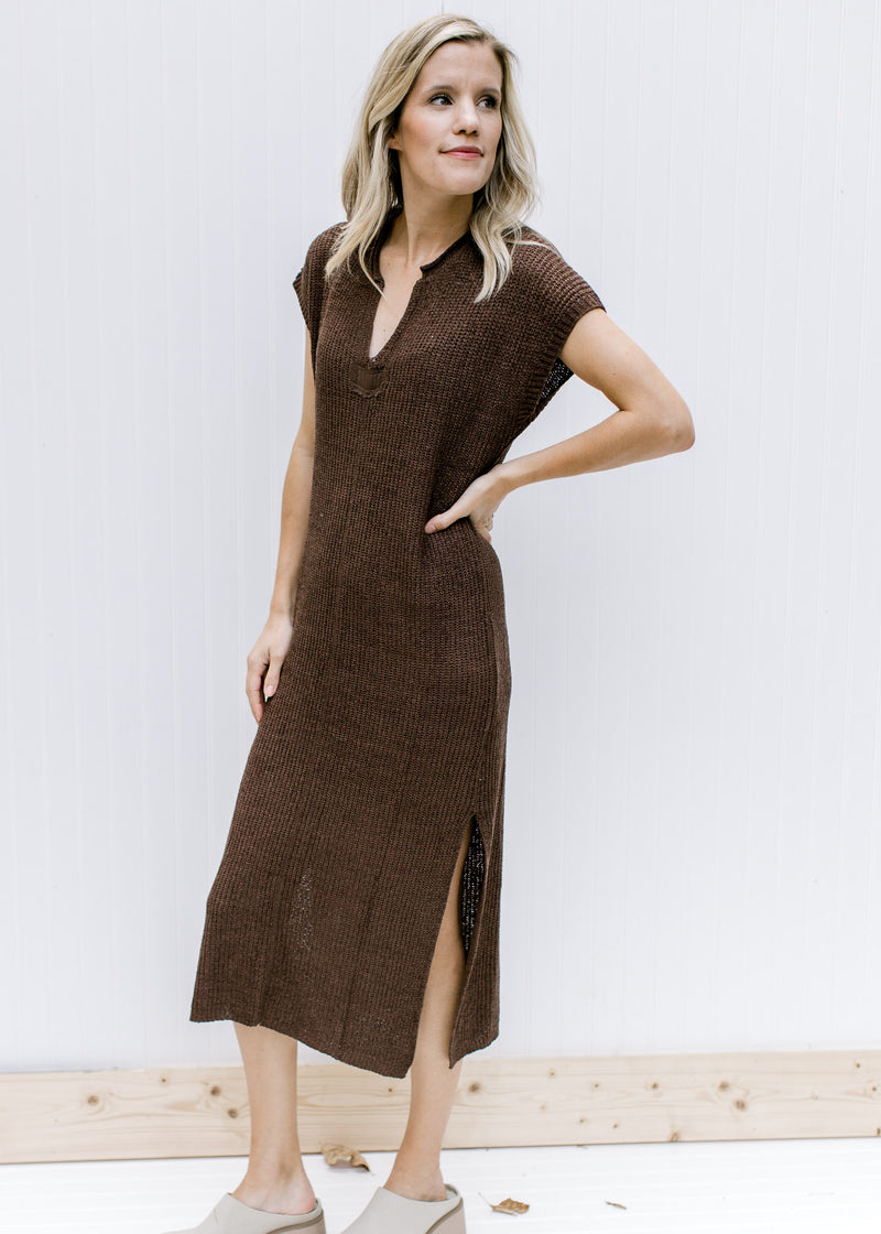 Model wearing a brown, fully lined midi with knit material, short sleeves and a v-neck. 