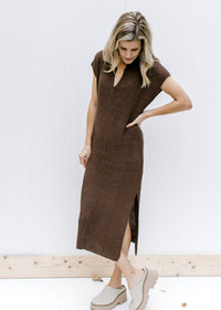 Model wearing mules with a brown, fully lined, knit midi with short sleeves and a v-neck. 