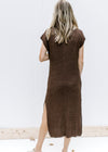 Back view of Model wearing a brown, fully lined midi with knit material, short sleeves and a v-neck.