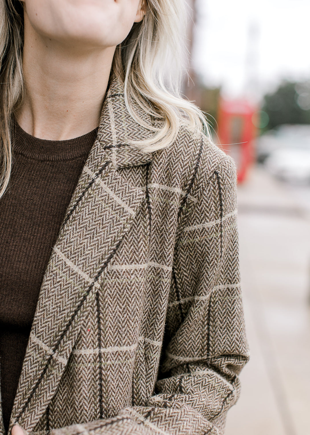 Close up of flap collar on a brown and cream plaid blazer with a soft wool blend and long sleeves.