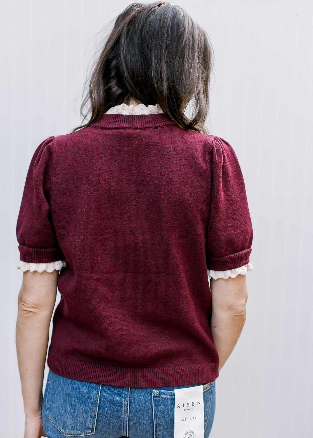 Back view of the Burgundy Crochet Layer Top showing short puff sleeves, cream neckline and cuff accents, and a ribbed hem.