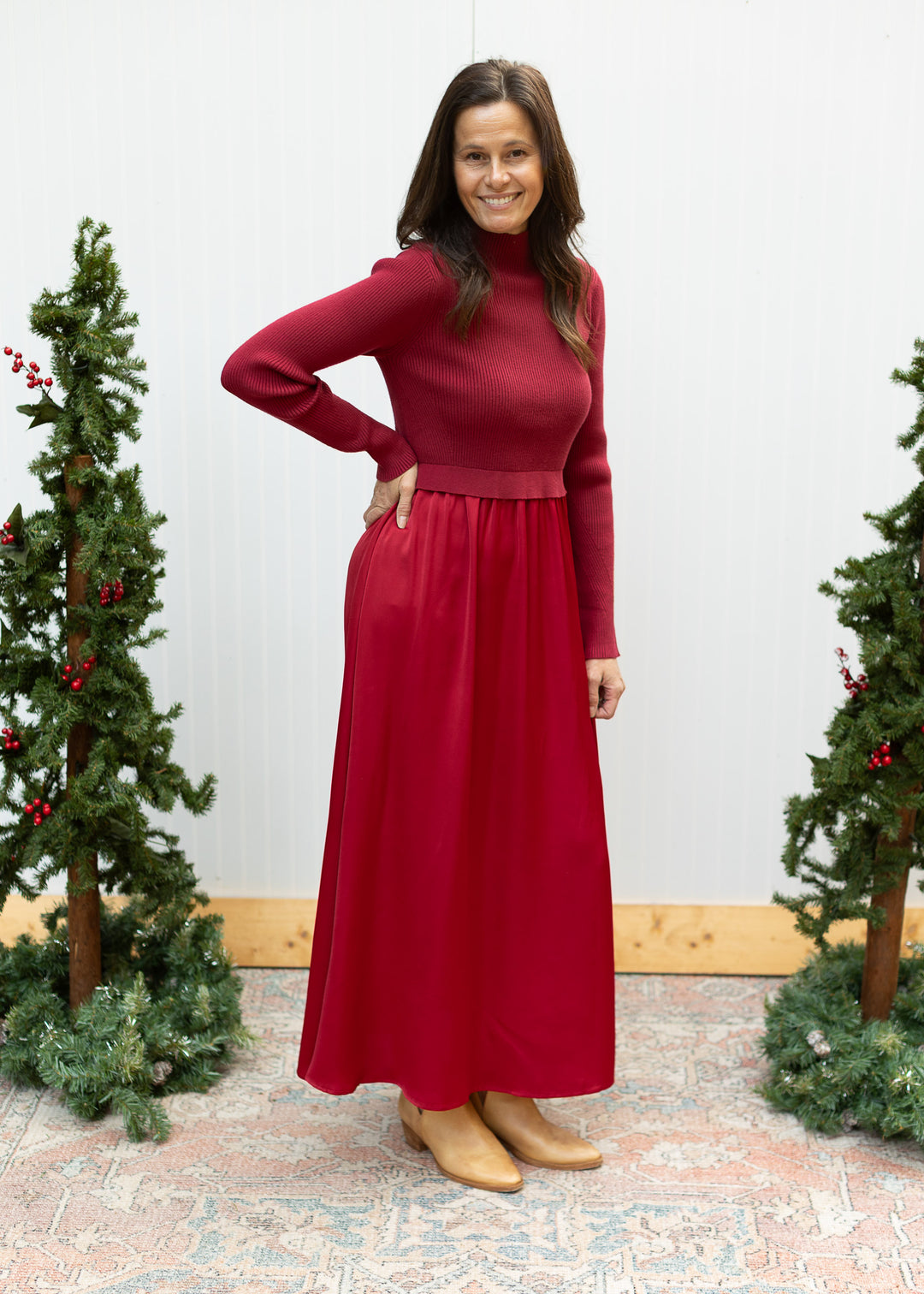 Front view of burgundy sweater dress with ribbed mock neck bodice, long sleeves and flowing satin maxi skirt.