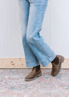 Model wearing a medium brown bootie with a round toe, knit sweater shaft and  1.5” stockman heel.