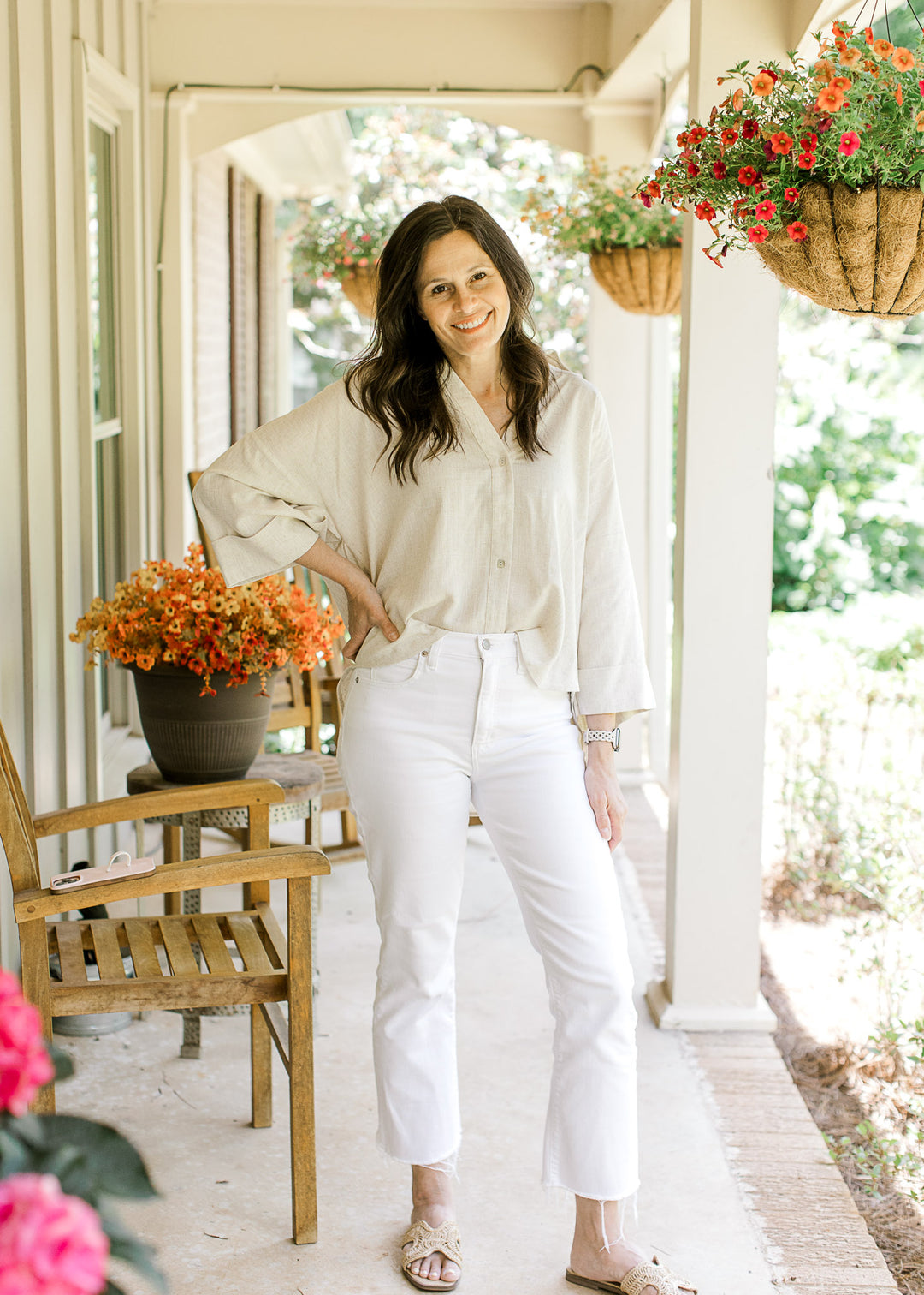 Model wearing white pants, sandals and an oatmeal top with button front and cuffed 3/4 sleeves.
