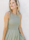 Close up of sleeveless knit ribbed top on a celery green midi with a lined flowy skirt. 