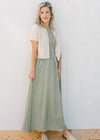 Model wearing cream short sleeve cardigan and a sleeveless celery green midi. 