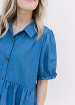 Close up of collar and bubble short sleeves on a chambray above the knee dress. 