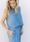 Side view of model wearing a chambray set with a cropped sleeveless top and wide leg bottoms.