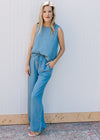Model wearing sandals and a chambray set with a sleeveless top and wide leg bottoms.