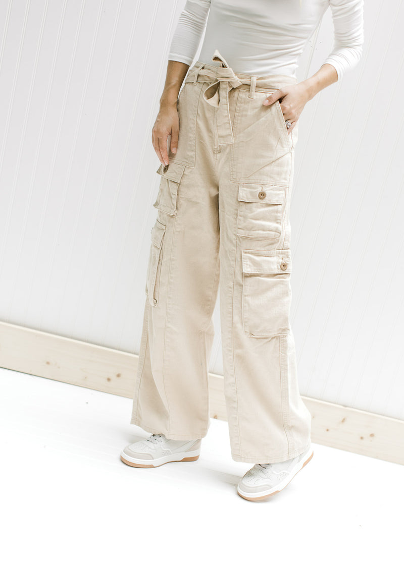 Model wearing champagne wide leg, cargo bottoms with elastic and a tie at the waist. 