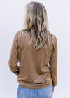 Back view of Model wearing a camel colored lightweight sweater with a round neck and long sleeves. 