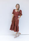 Model wearing booties with a wine midi dress with a ribbed bodice, short puff sleeves and pockets. 