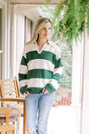 Model wearing a green and cream striped v-neck sweater with exaggerated collar. 