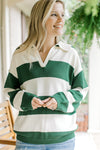 Model wearing a green and cream striped sweater with long sleeves and a collar. 