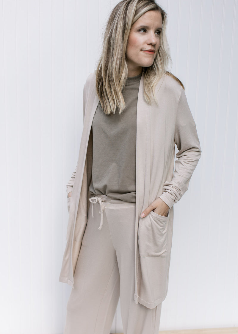 Model wearing a tan kimono with tan wide leg pants with pockets, rayon material and a tie  waist.