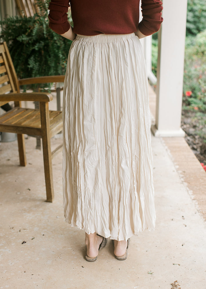 Back view of creamy white maxi with crinkle fabric, elastic waistband and a full lining. 
