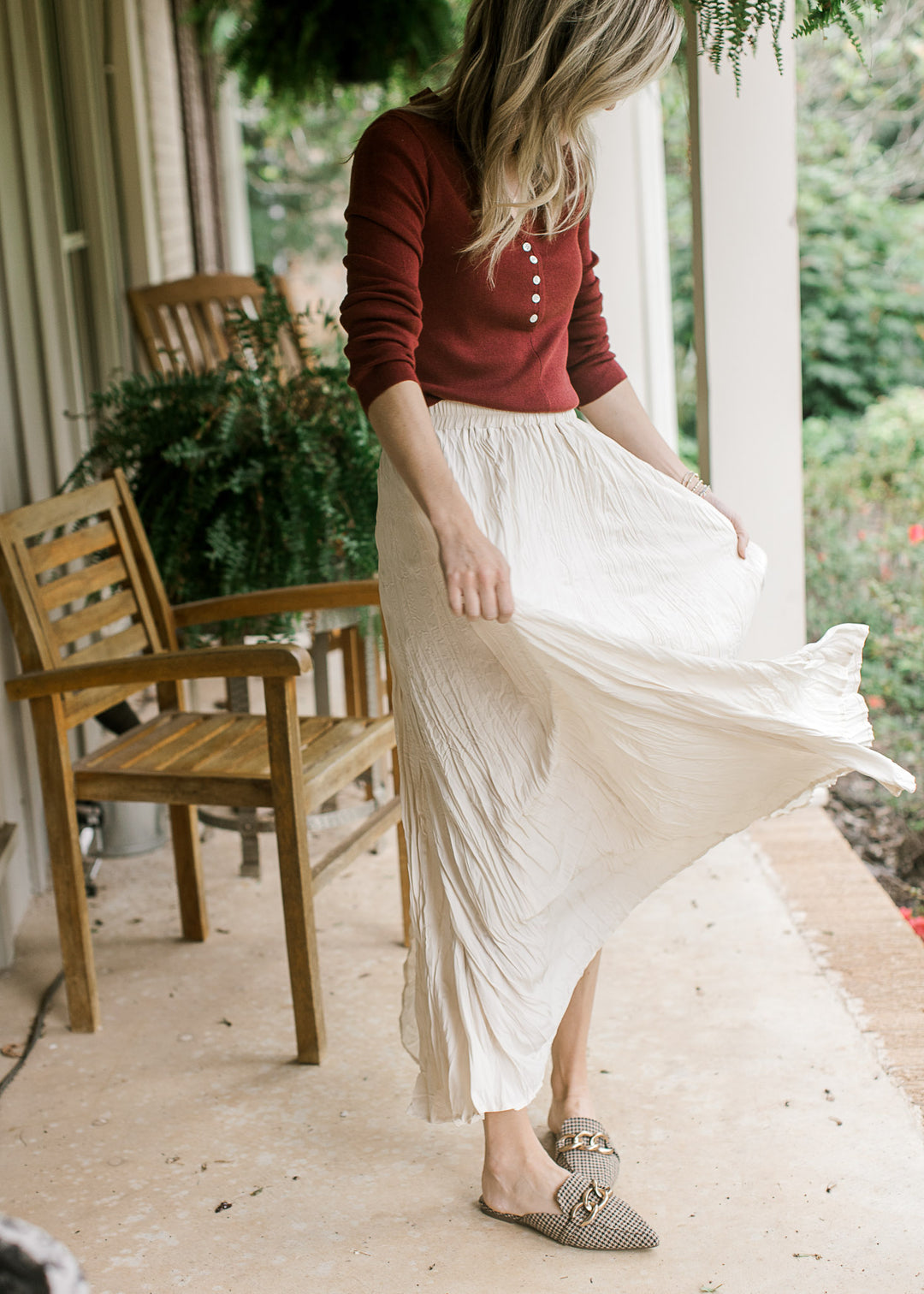 Model twirling in a creamy white maxi with crinkle fabric, elastic waistband and a full lining. 
