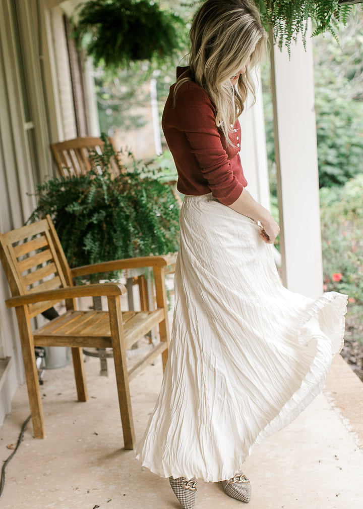 Side view of creamy white maxi with crinkle fabric, elastic waistband and a full lining. 