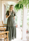 Model wearing an olive v-neck maxi with an elastic waist and short sleeves. 