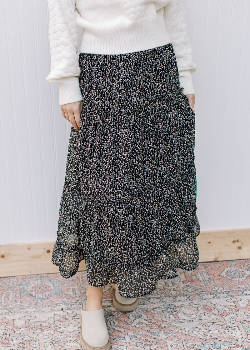 Model wearing mules with a black midi with white ditsy flowers, elastic waist and pockets. 