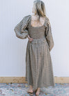 Back view of smocking and square neck on a brown and cream plaid dress with bubble long sleeves. 