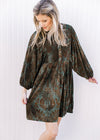 Model wearing a green velvet dress with brown floral, 3/4 batwing sleeves and button front. 