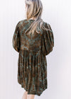 Back view of Model wearing a green velvet dress with brown floral and 3/4 batwing sleeves.