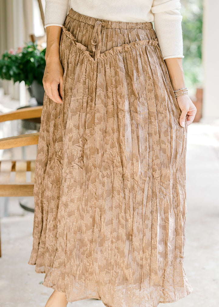 Model wearing a toffee midi with subtle lace, v-shaped ruffle at the waist and elastic band. 