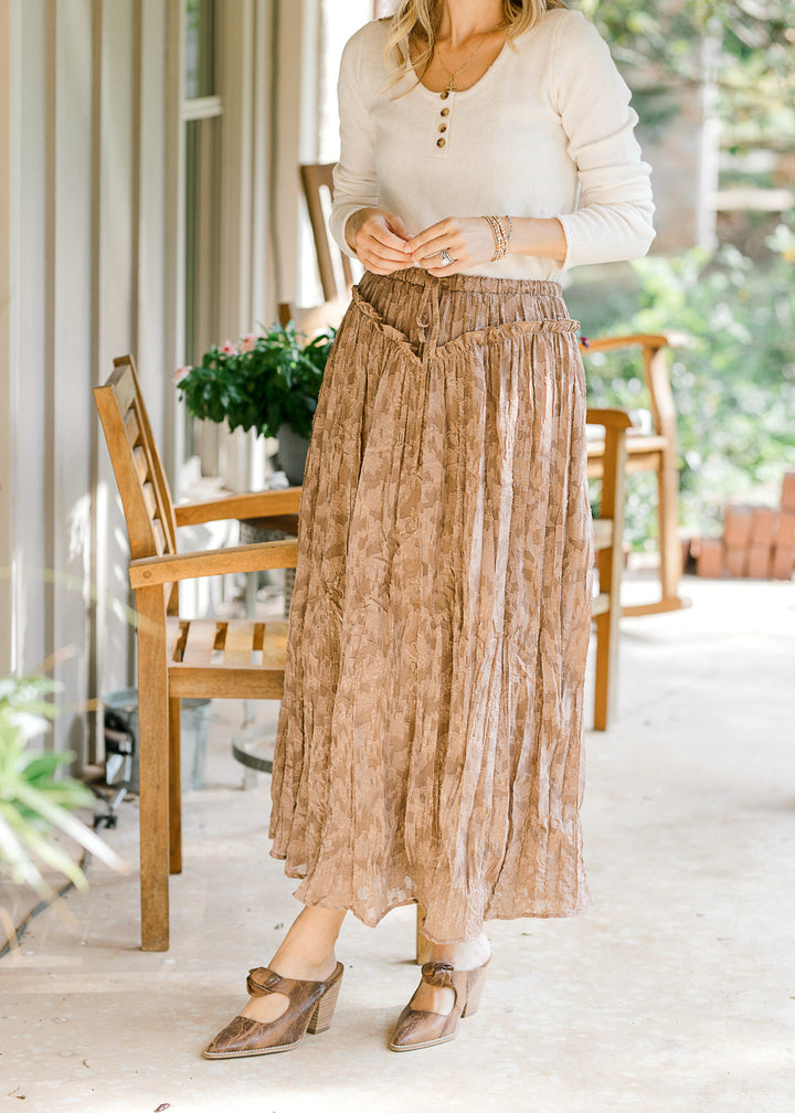 Model wearing a cream top and toffee midi with subtle lace,tie ant waist and elastic band. 