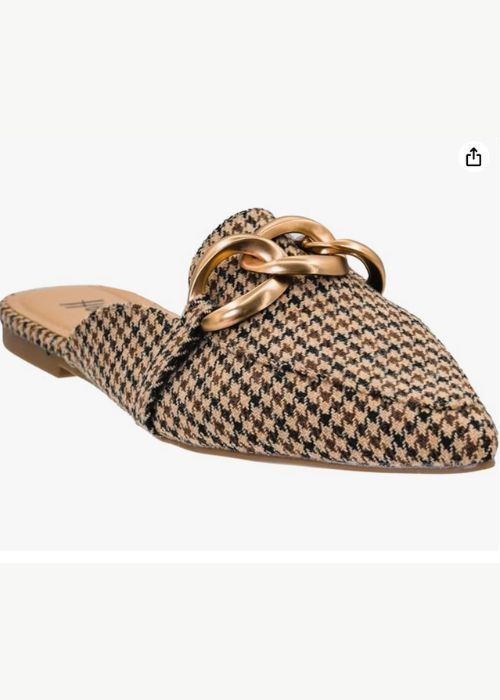 Front view of a black and tan houndstooth slip on with a pointed-toe and gold chain embellishment. 